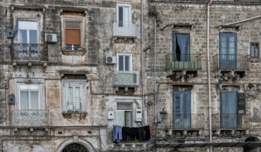 Taranto, Italy, 30 November, 2023: shabby chic derelict buildings with laundry hanging from the