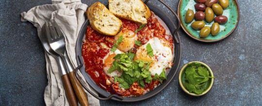Middle Eastern and Maghrebi healthy dish Shakshouka made of eggs and tomato sauce served in pan