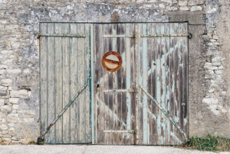 Old wooden closed garage with no parking sign