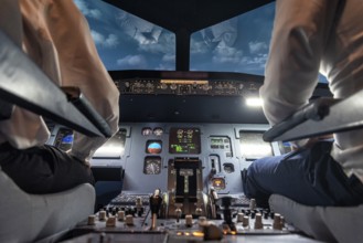 Pilots in the cockpit of an aircraft during a flight