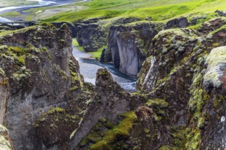 Iceland. The beautiful and mysterious canyon Fyadrarglyufur. Cloudy summer day. River with glacial