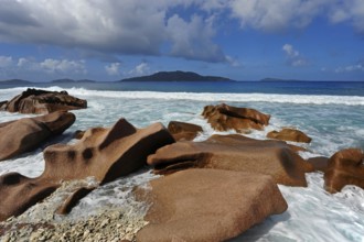 Granite rocks washed out in the water at Anse Banane, La Digue Island, behind the island Felicite,