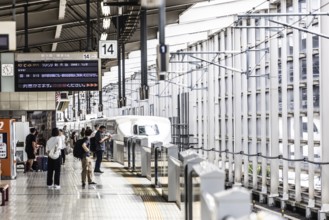 KYOTO, JAPAN - SEPTEMBER 24 2024: A Shinkansen high-speed bullet train arriving at Kyoto Station in
