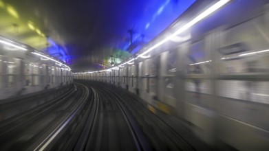 First person window perspective view of underground Paris subway tunnel with station and moving