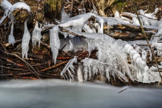 Creek with frozen watersculptures in winter