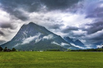 Heavy clouds covered the sky. Jostedalsbreen Park. Picturesque valley surrounded by high forested
