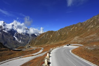 Austrian Alps. Tape highway winds between hillsides yellowed. Excursion to the picturesque