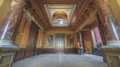 A magnificent corridor with marble columns and richly decorated ceilings in warm colours, Villa