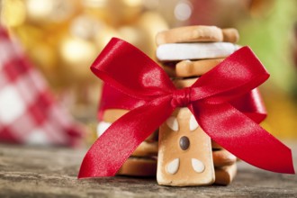 Cookies with red bow against Christmas lights