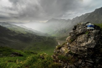 View from Mountain Entschenkopf near Oberstdorf in dynamic weather with rain