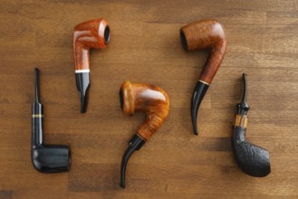 Collection of pipes on a wooden base