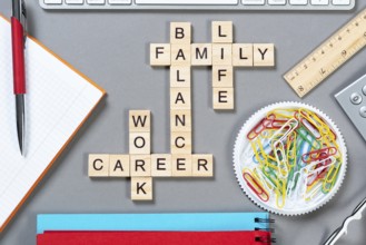 Business motivation concept with words from cubes. Still life of office workplace with crossword.