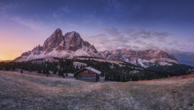 Passo Erbe under the mountain Peitlerkofel, or Sass de Putia before sunrise with wood hut