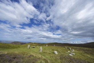 Druids Circle, stone circle in wide landscape with pastures in the mountains, Penmaenmawr,