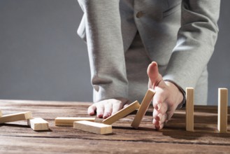 Business woman hand block domino effect. Business risk management and stabilisation situation. Life