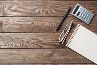 Still life of accountant vintage workspace with office accessories. Flat lay old hardwood desk with