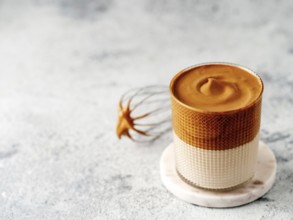 Trendy korean drink - dalgona coffee. Glass jar with cold or hot beverage - whipped instant coffee