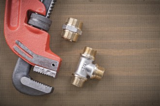 Pipe wrench brass plumbing fixtures on cleaning mesh filter grid