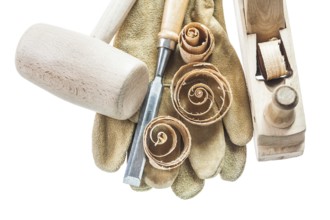 Safety gloves chisel shavings wooden hammer planer isolated on white