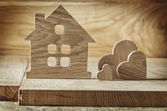 Vintage wooden toys house and three hearts on wood background