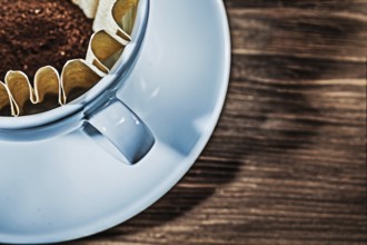 Very close up view cup with filter and grinded coffee