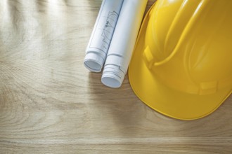 Building helmet blueprints on wooden board