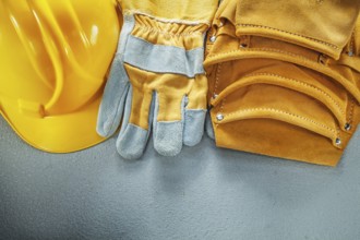 Tool belt protective gloves cap on concrete background