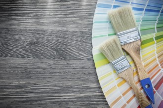 Paint brushes color palette on wood board