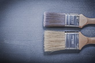 Paintbrushes on wooden board horizontal image construction concept
