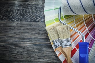Paint brushes roller color pantone fan on wooden board