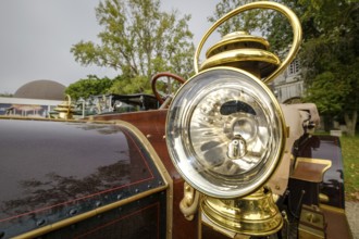 Lisbon, Portugal - Oct 15, 2023: Detail of 1904 Mercedes Simplex - external headlight in brass