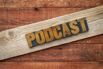 Podcast rustic sign - letterpress wood type over grained cedar plank against red barn wood