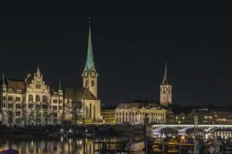 View of Limmat river with Fraumunster and st. Peter church in evening, Zurich