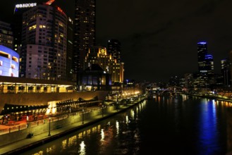 Central melbourne city river side modern urban skyline at night in australia