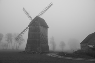 Kozlak windmill in the fog in Boruja Koscielna, Poland, Europe