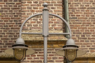 Lantern in front of an old brick wall