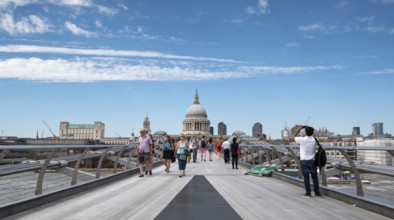 London, UK, July 5, 2019: People walking on the millennium bridge and Saint Paul Cathedral in