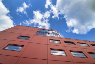 Red house façade with reflective windows