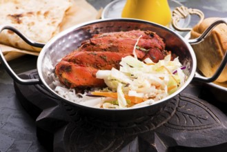 Close-up of a plate of chopped tandoori chicken