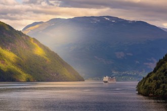 Norway colorful sunset Nordfjord fjord panorama with mountains landscape and cruise ship