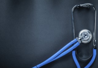 Stethoscope on black background top view medicine concept