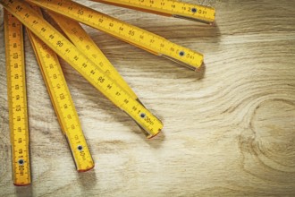 Wooden meter on wood board directly above construction concept