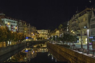 Embankment of Tepla river in the center of Karlovy Vary in evening, Czech republic