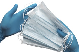 Doctor holding lot medical face mask in two hands blue gloves isolated on white background. Concept