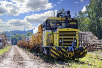 Yellow Tka8 locomotive work train on Salo Railway Station for coastal railway maintenance in July
