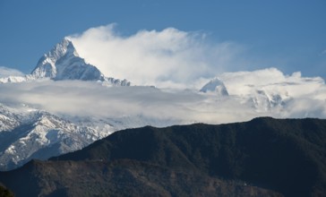 The famous Annapurna massif mountains in the Himalayas covered in clouds, snow and ice in north