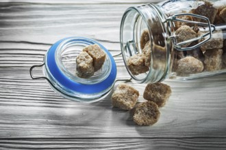 Glass with brown sugar on wooden board