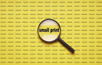 small print enlarged with magnifying glass magnifier loupe, business concept