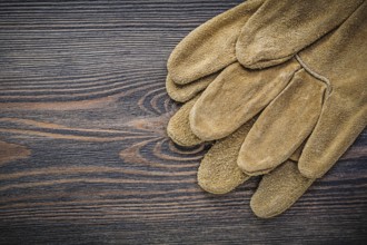 Leather safety gloves on wooden board gardening concept