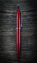 Red biro pen on vintage wooden board